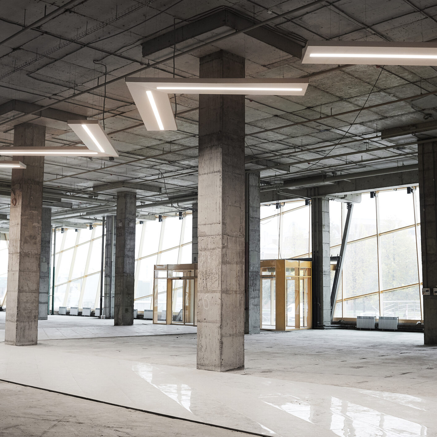 Background image of empty building under construction with concrete columns and graphic ceiling lamps, copy space