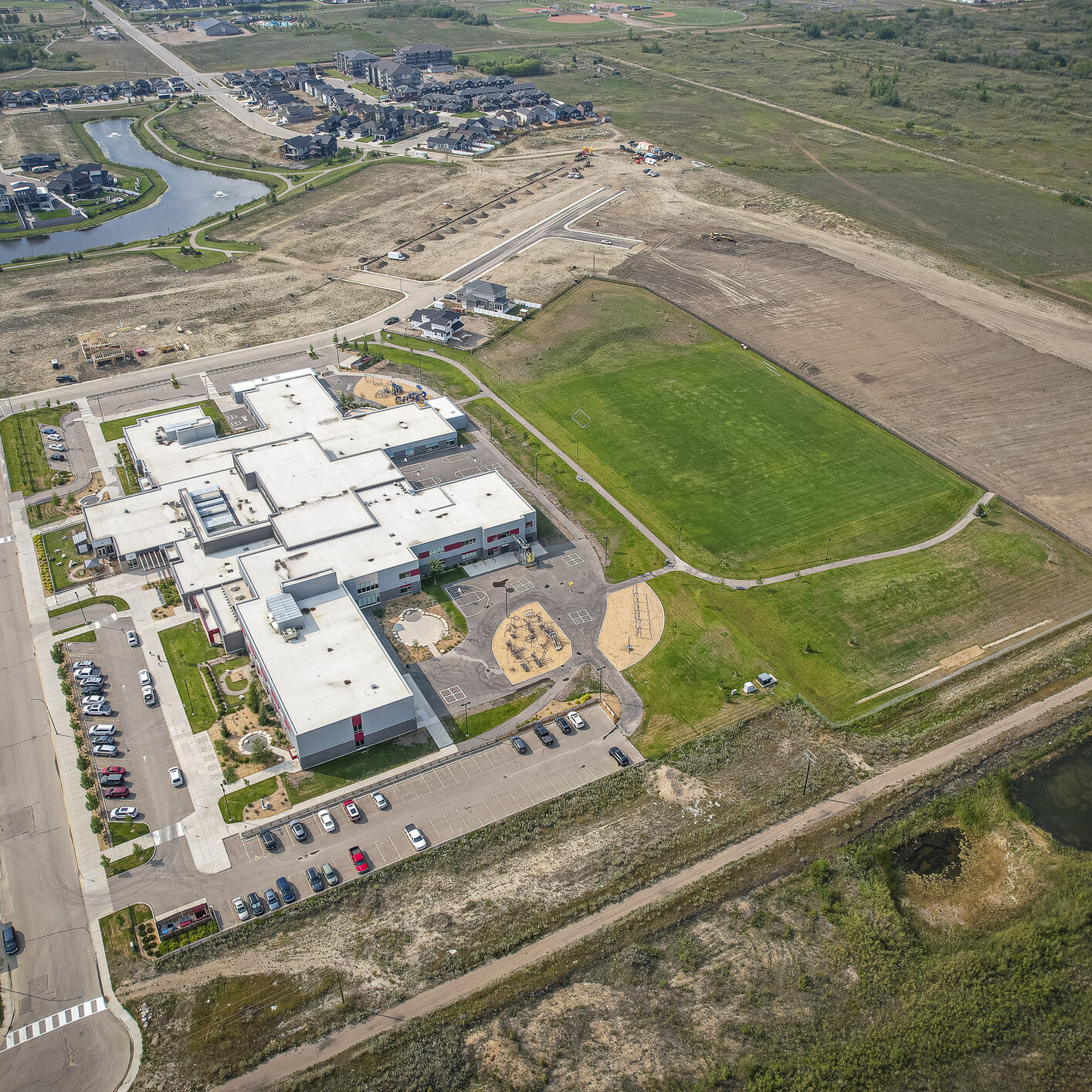 Drone image capturing the town of Martensville in Saskatchewan during the summer season, highlighting its suburban and residential areas surrounded by lush greenery